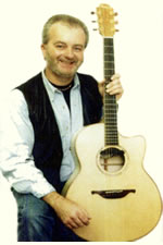 Steve Ashcroft holding his guitar
